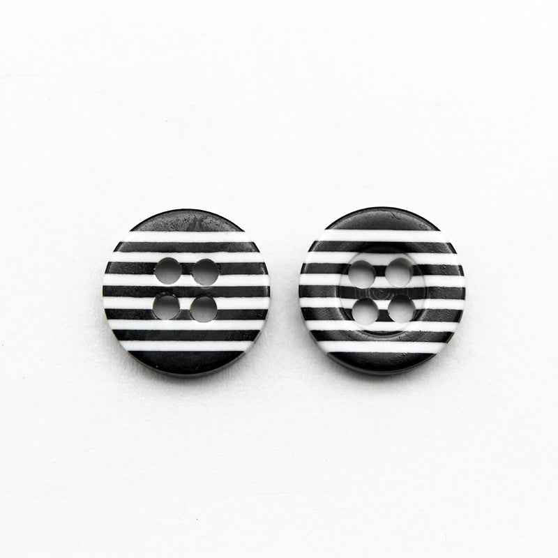 Pair of dark striped resin buttons with white horizontal lines and four holes