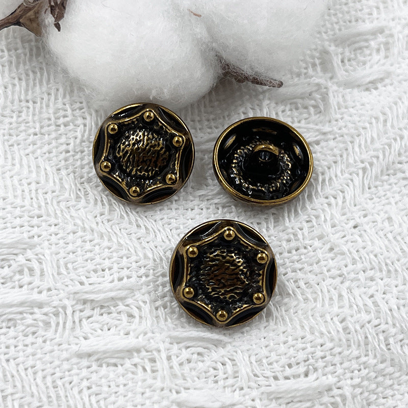 18mm decorative shank button, dark front with gold-tone rim and stud details