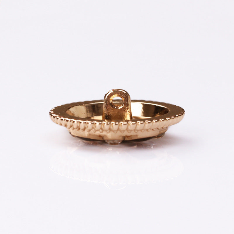 Round button side view: gold-tone rim with center shank attachment