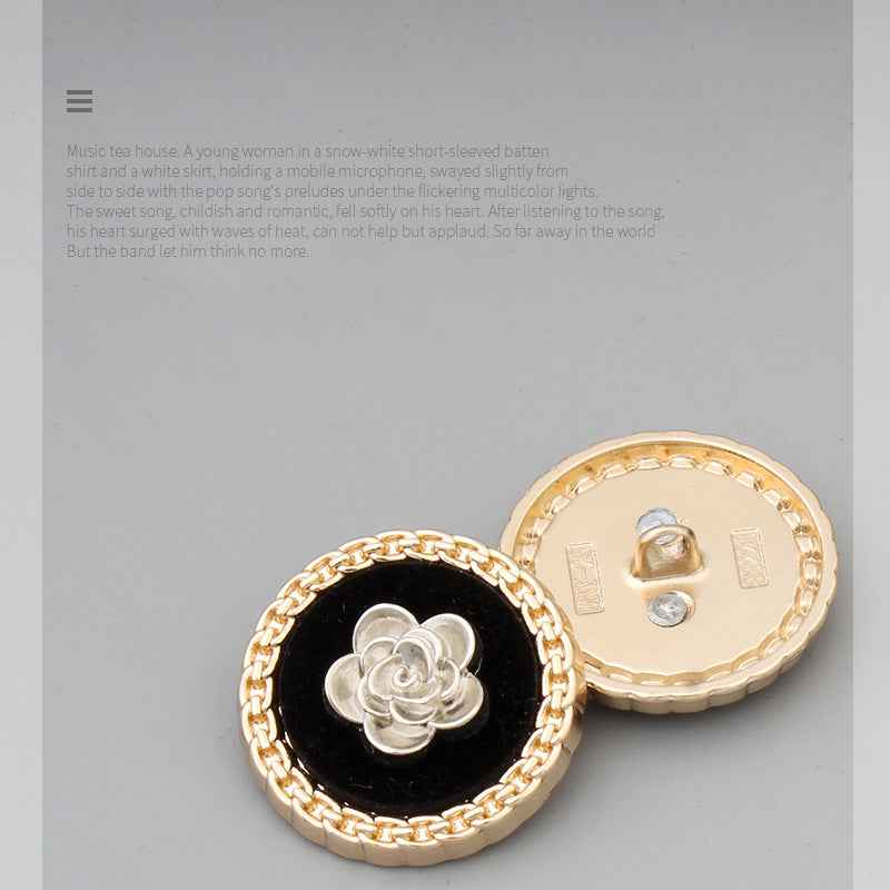 Two round buttons: black-faced silver flower front and gold-tone back with shank.