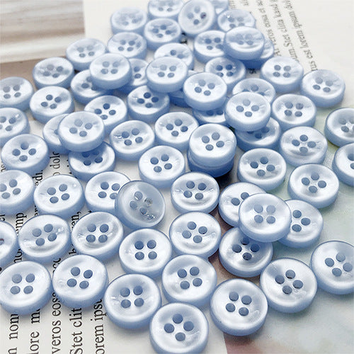 Light blue round 4-hole shirt buttons, round face with four holes