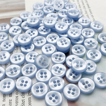 Light blue round 4-hole shirt buttons, round face with four holes