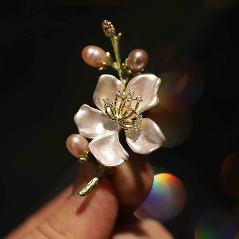 Peach blossom brooch pin with gold stem, pink petals, and pearl drops