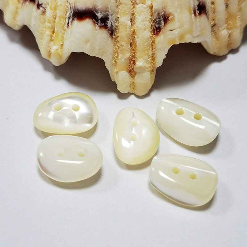 Irregular mother-of-pearl shell buttons, cream/white tone with two holes each