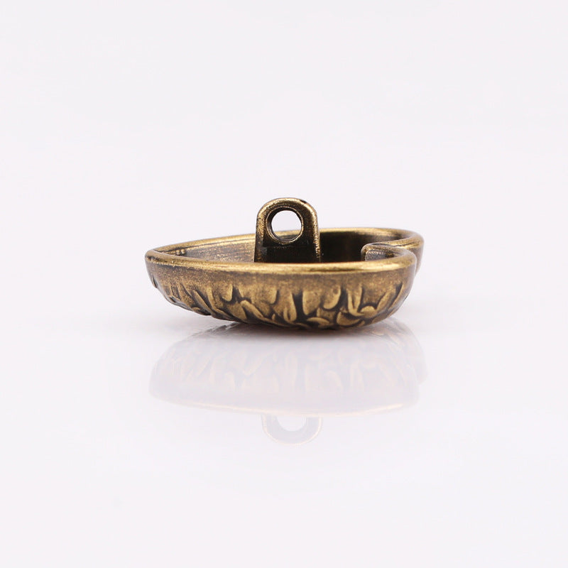 Heart-shaped textured metal shank button, antique gold; back view with loop shank