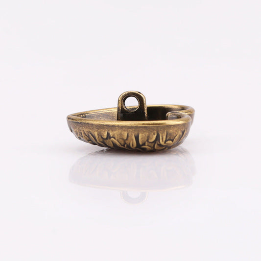 Heart-shaped textured metal shank button, antique gold; back view with loop shank