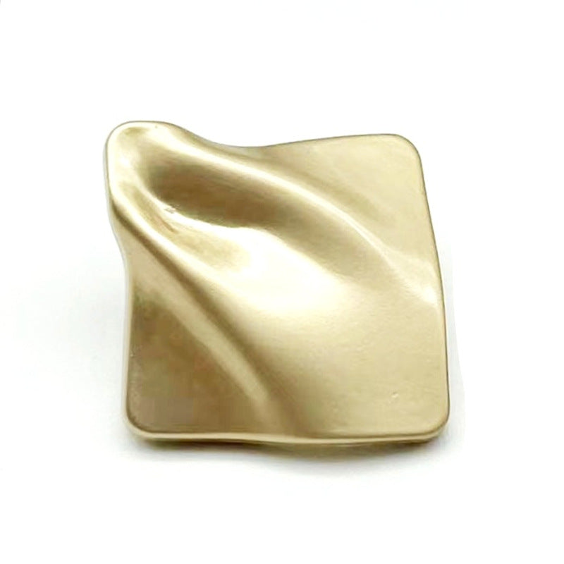 Gold diamond-textured metal shank button with square dimpled front