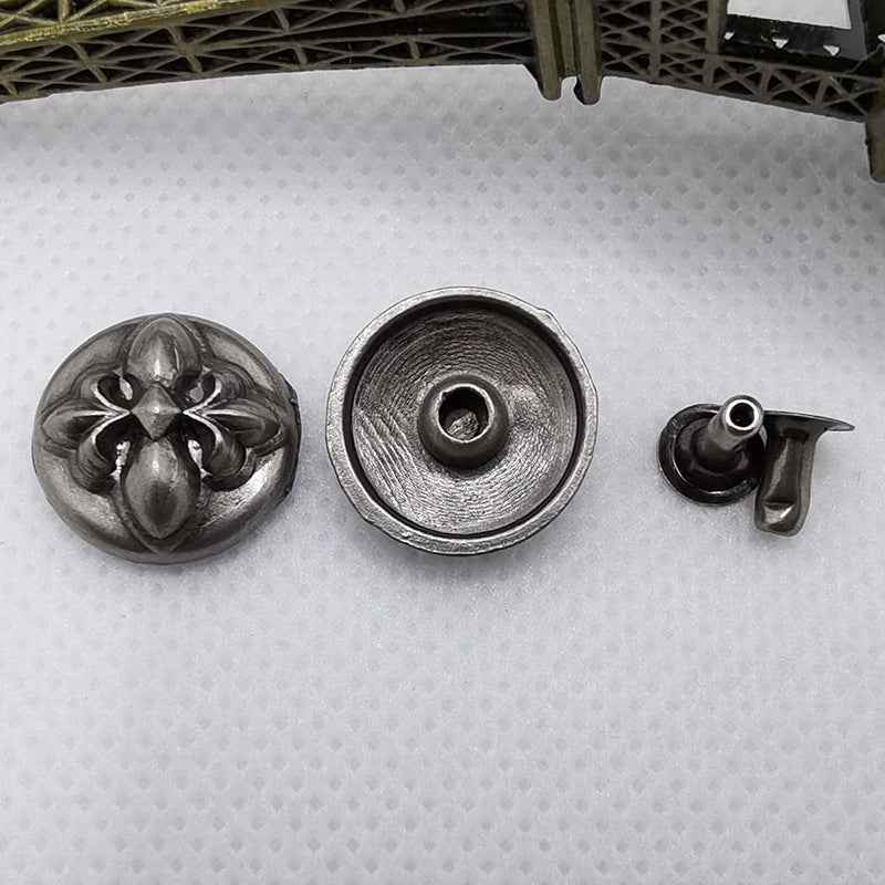 Silver-toned round rivet stud fronts with embossed design, plus a back plate with hole.