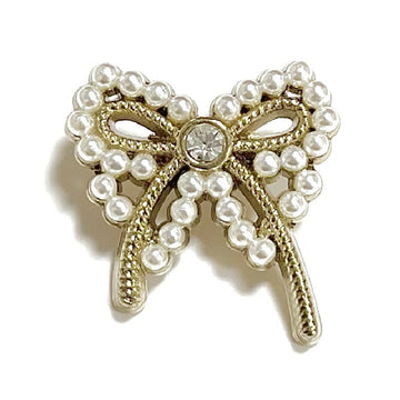 Small bow button with metal shank; pearl-inlaid loops and round rhinestone center