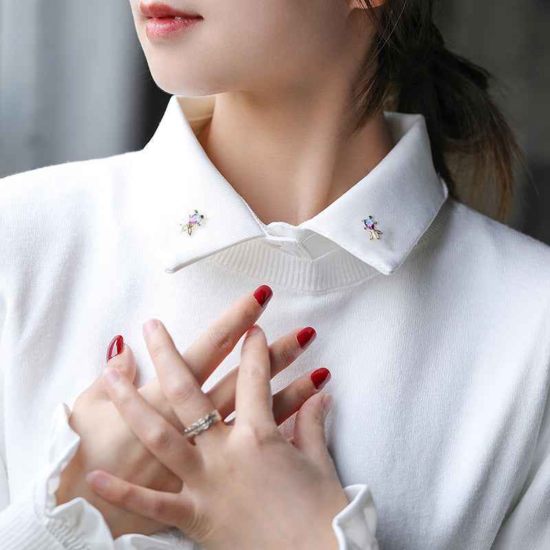 Goldfish zircon brooch on white shirt collar with small blue-purple crystal detail