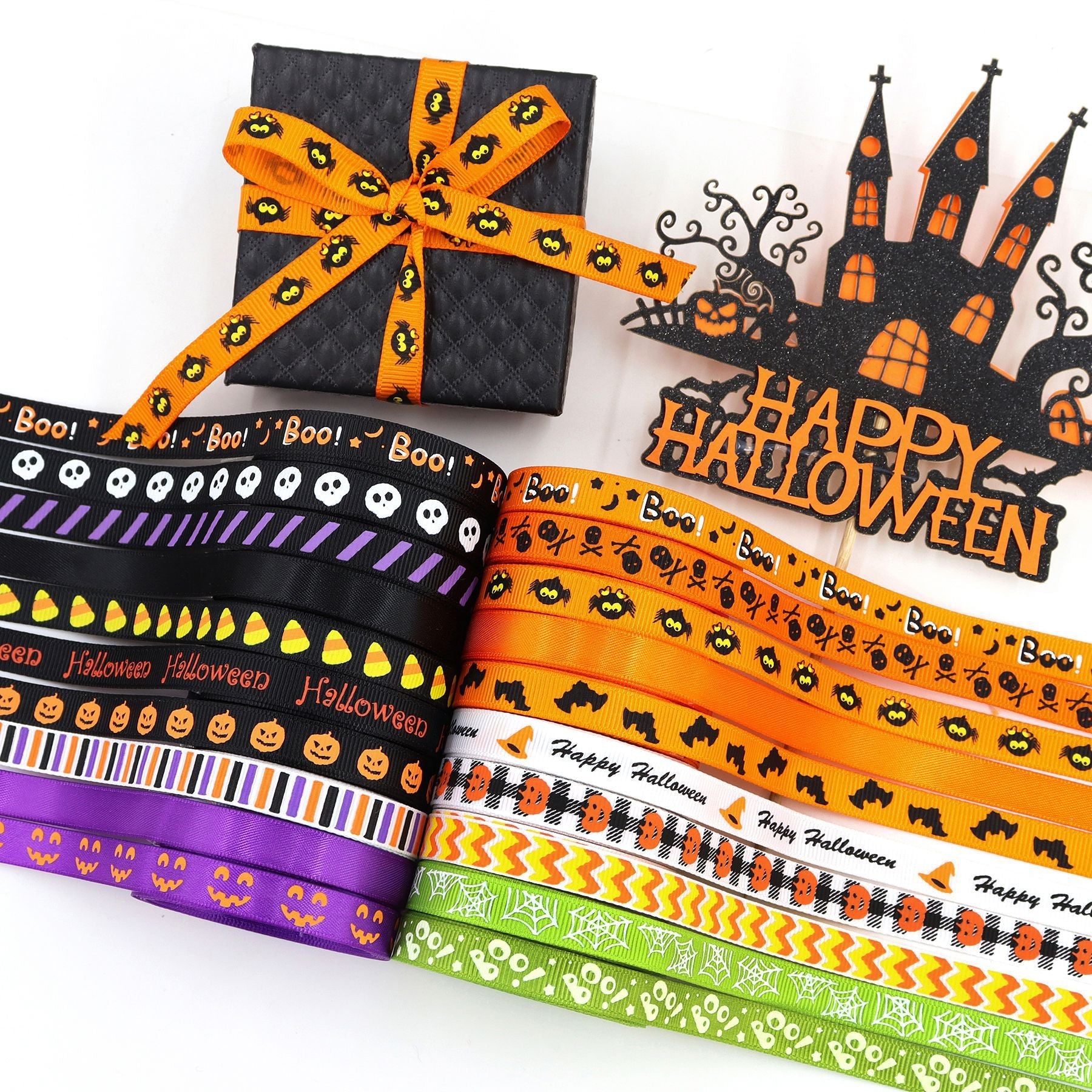 Halloween ribbon strips close-up: 'Boo!' text, pumpkins and skulls in orange, black, purple