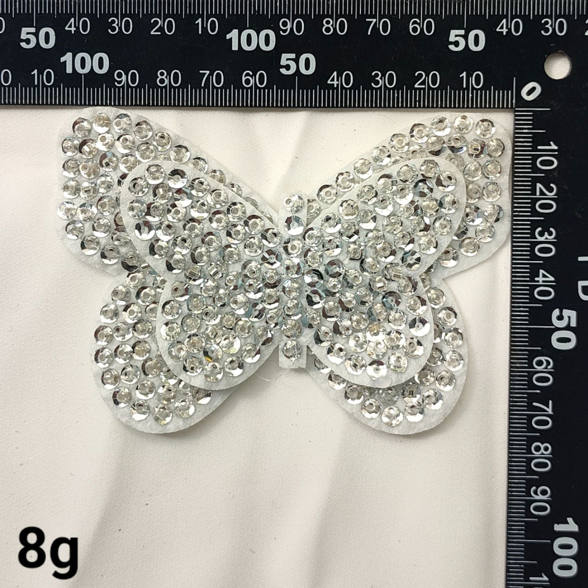 Silver rhinestone bow patch with glittered details and scalloped edges