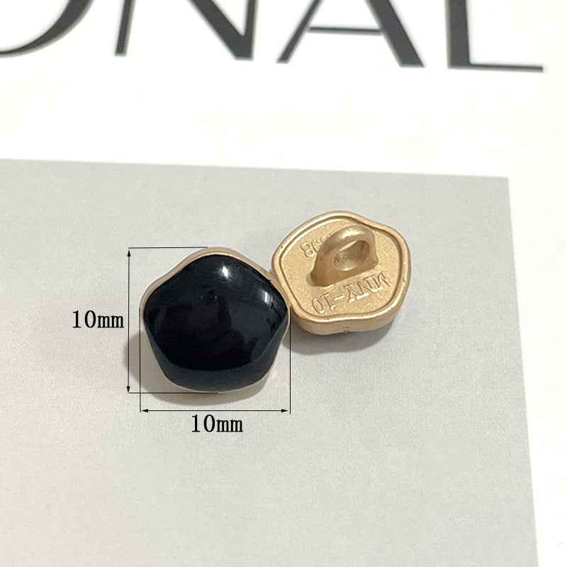 10mm metal shank button with glossy black front and gold underside
