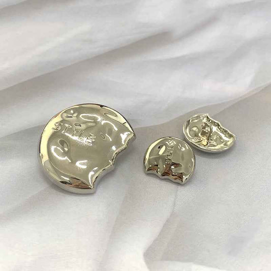 Silver semi-circular metal shank buttons set, engraved “STYLE” on front faces