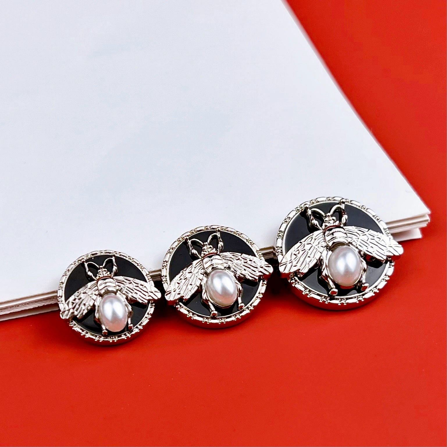 Round bee pearl metal shank buttons with posts, silver and gold, black enamel design
