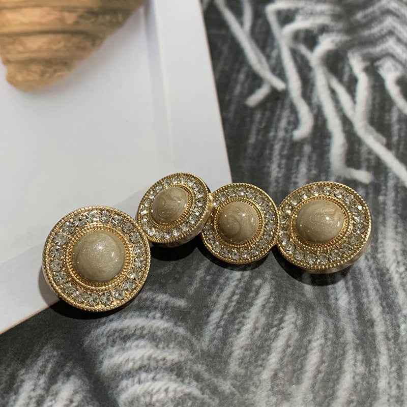 Gold-tone round buttons with rhinestone edge and taupe center, front view
