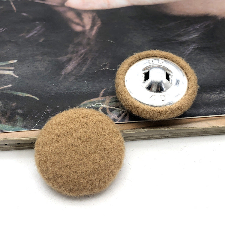 Two 28mm fabric-covered buttons: beige/tan textile face with silver metal snap