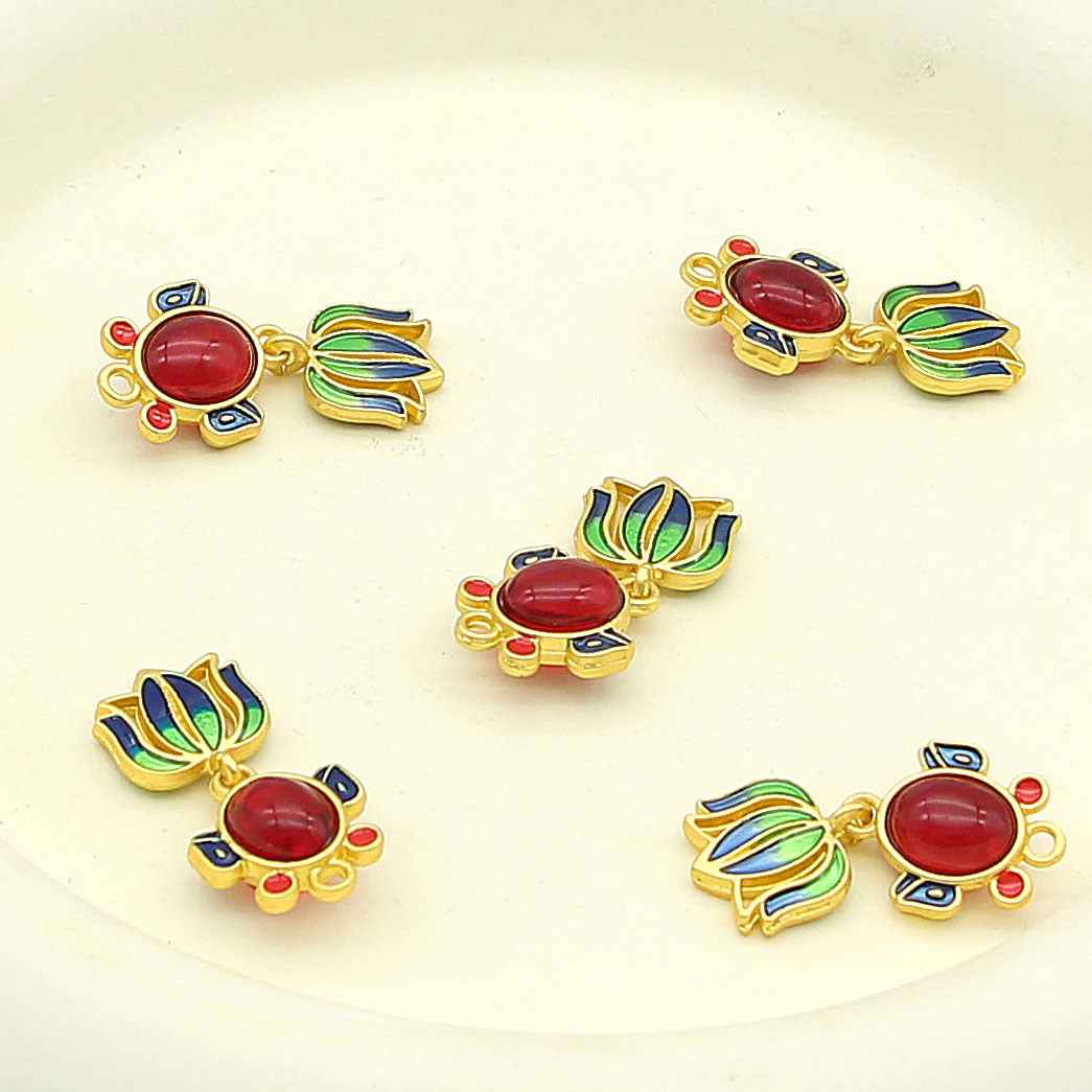 Set of goldfish-shaped metal decorative buttons with red centers and blue/green enamel fins