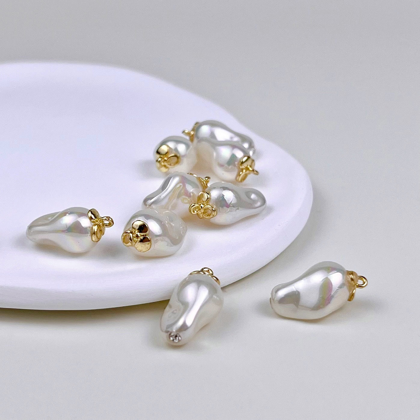 Baroque pearl-shaped metal buttons: white teardrop pearls with gold ring tops