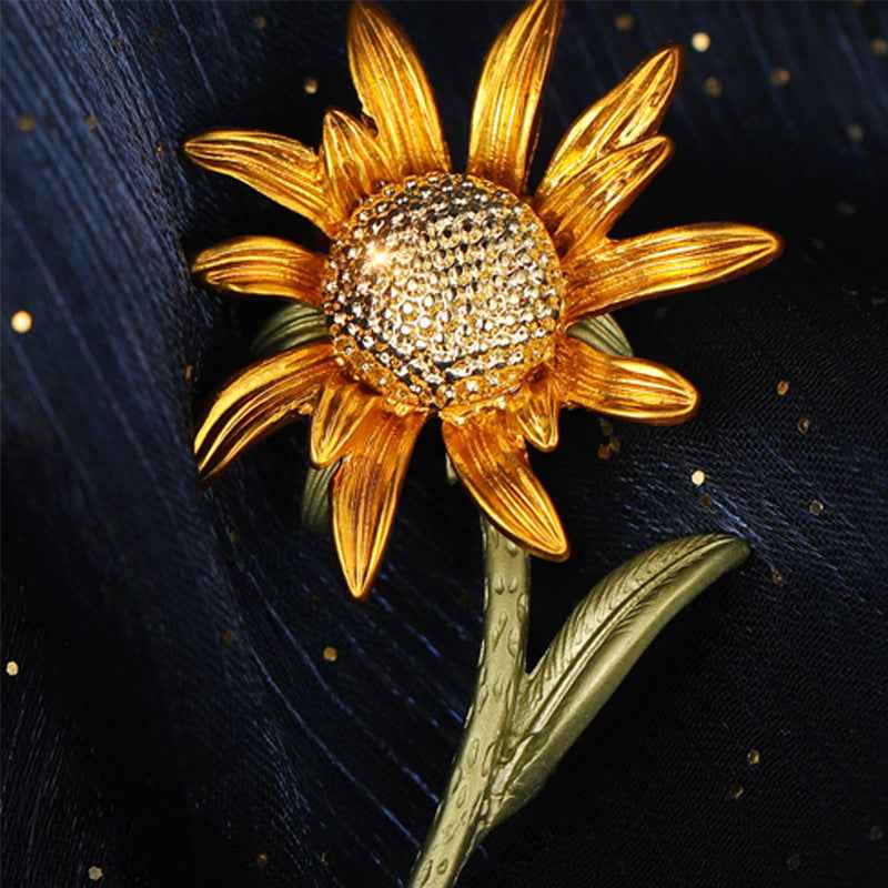 Gold-tone sunflower enamel brooch pin with rhinestone center and green stem