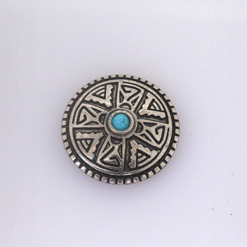 Turquoise metal stud button with geometric sunburst pattern and blue center