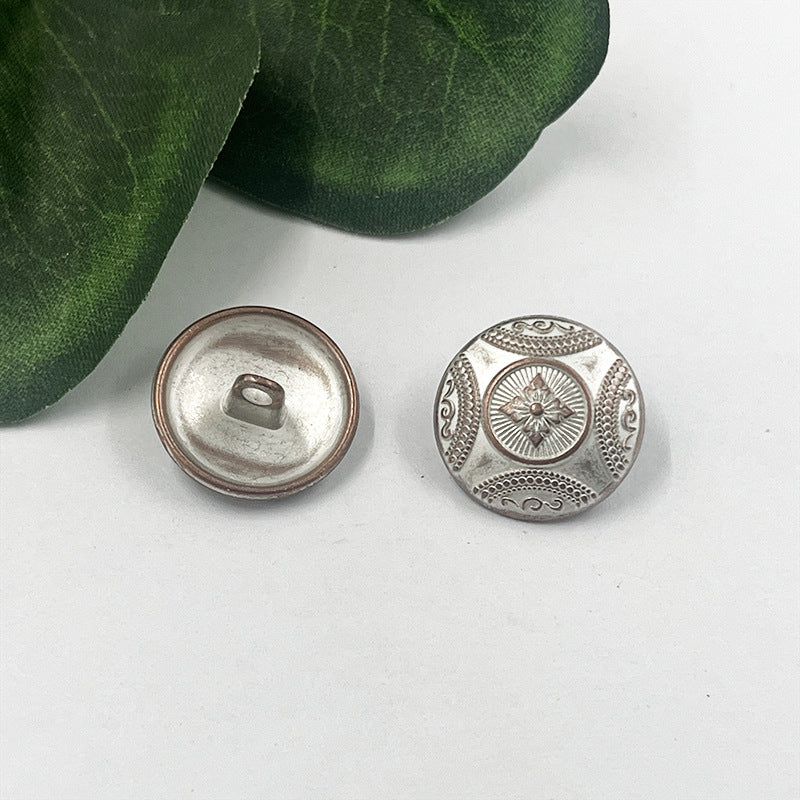 Silver metal shank button, front with flower engraving and matching shank back