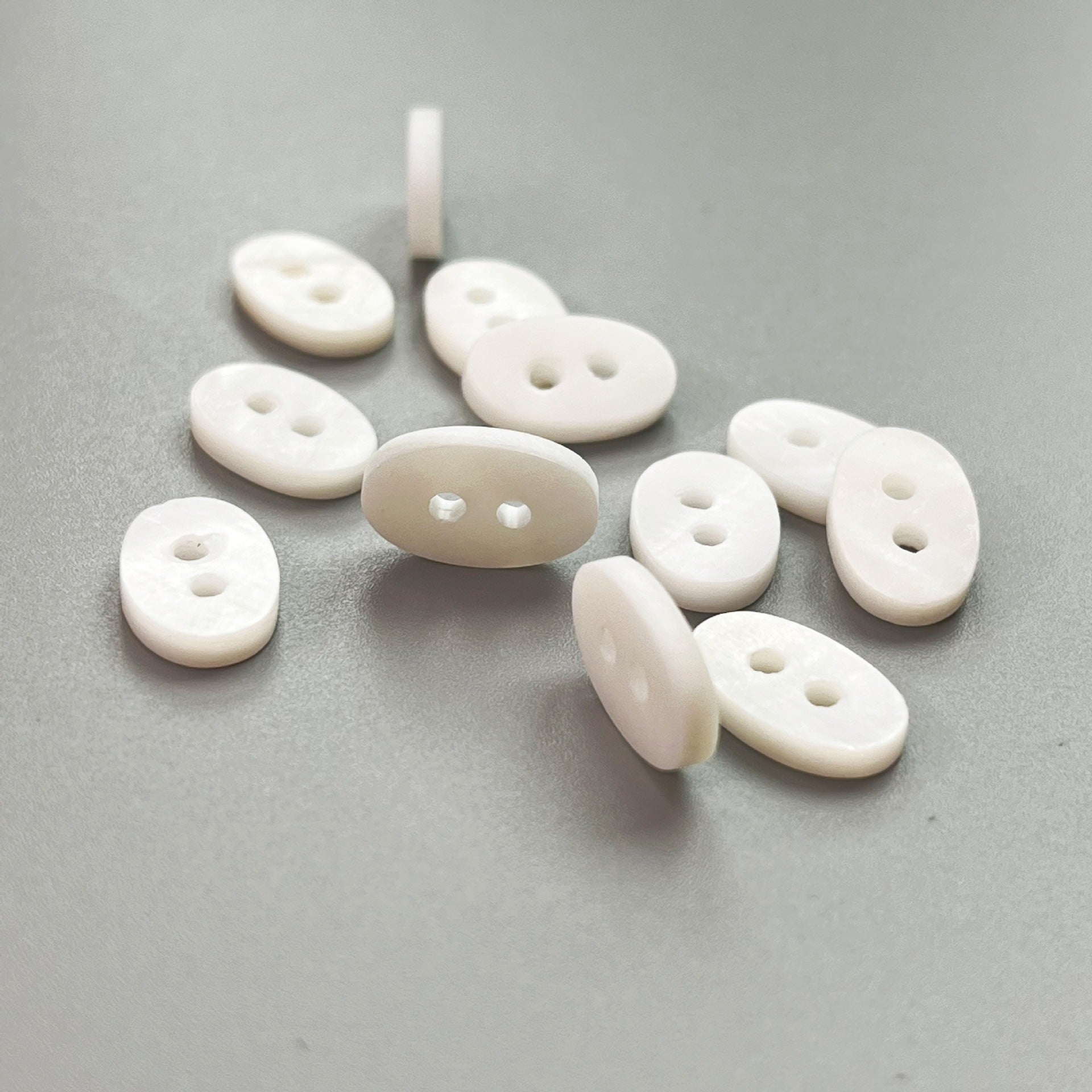 Natural white oval shell buttons, 32/34L, 2-hole set of 20—mixed shapes