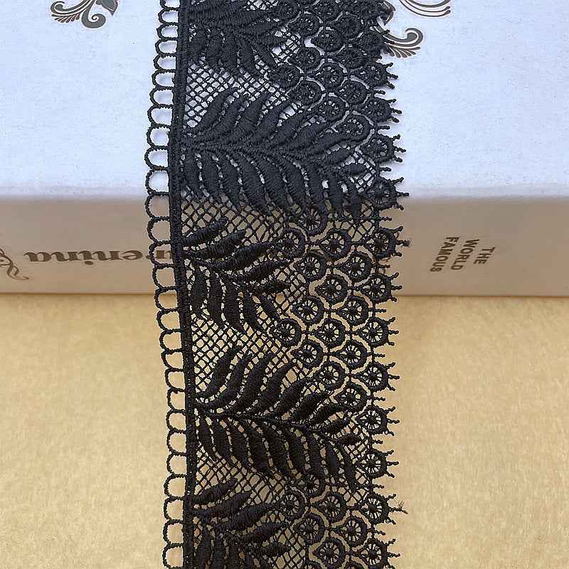 Black lace trim with embroidered leaf motif on mesh and decorative scalloped border