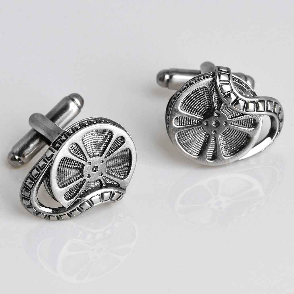 Round antique silver cufflinks with film reel design and decorative border detail
