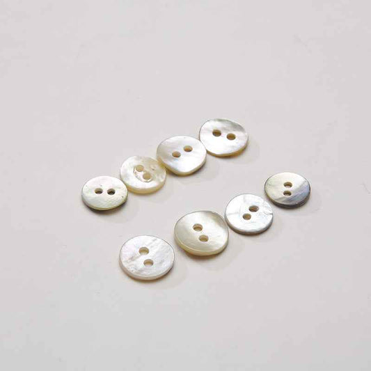 Set of 2-hole round mother-of-pearl buttons with subtle iridescent sheen and gold-toned holes