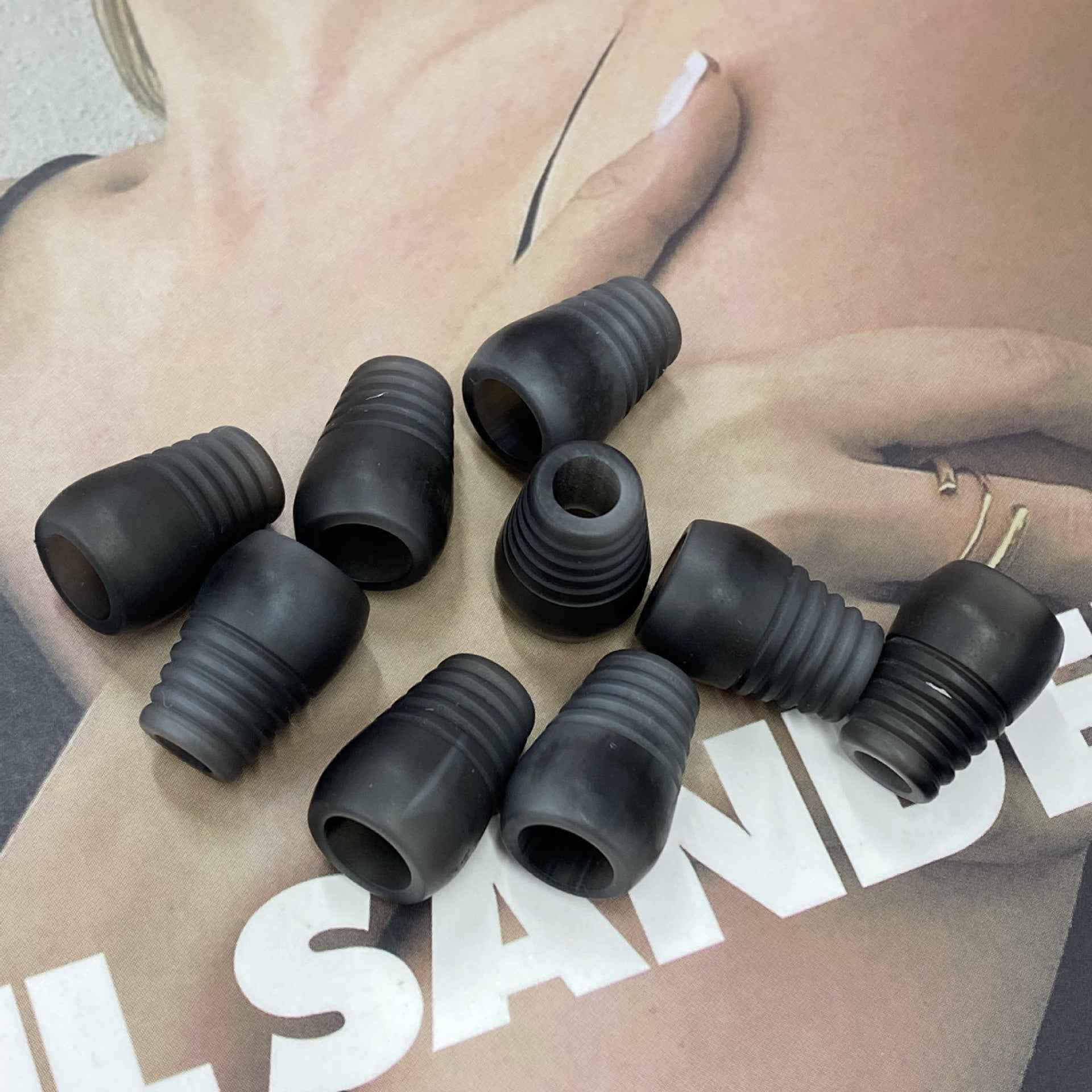 Dark gray resin bell cord end stoppers, ribbed shape with open end
