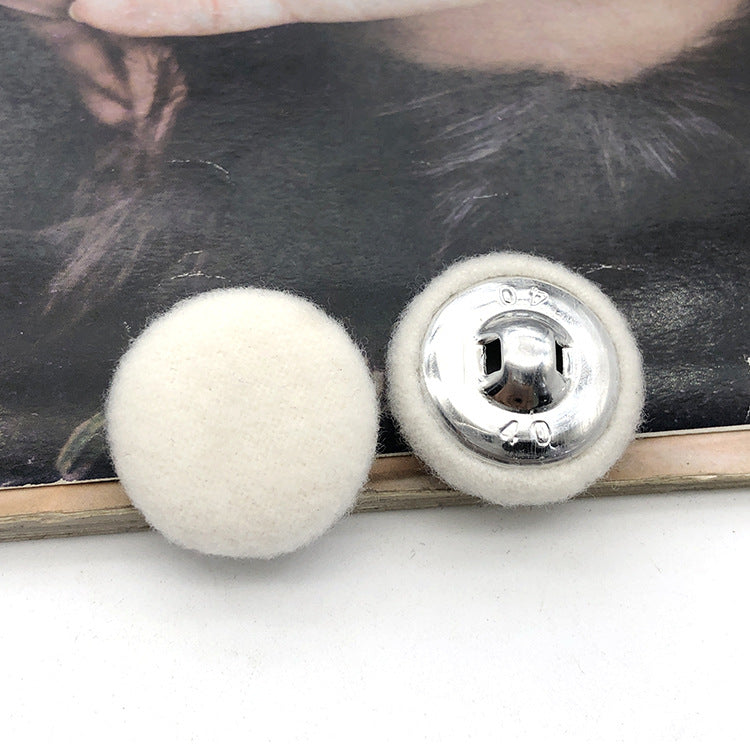 Two 28mm fabric-covered buttons: white textile face with silver metal snap