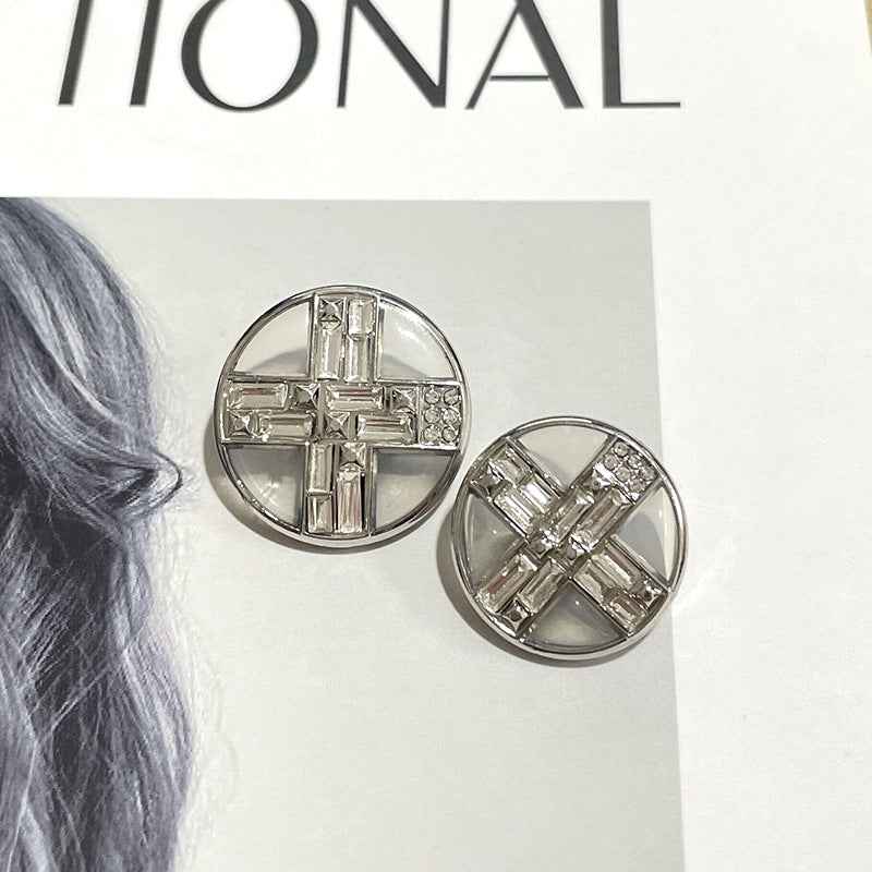 Two silver round buttons with transparent cross rhinestone design and metal shank