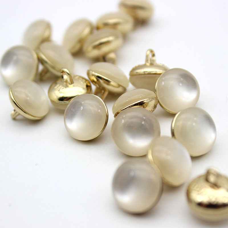 Pearl white cat-eye shank buttons with gold loop backs, round, mixed sizes