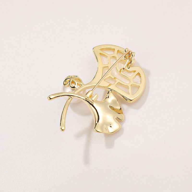Ginkgo leaf brooch pin angled view with mother-of-pearl shell and pearl