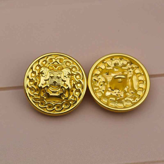 Set of two gold tone lion crest buttons with raised ornate pattern, metal shank