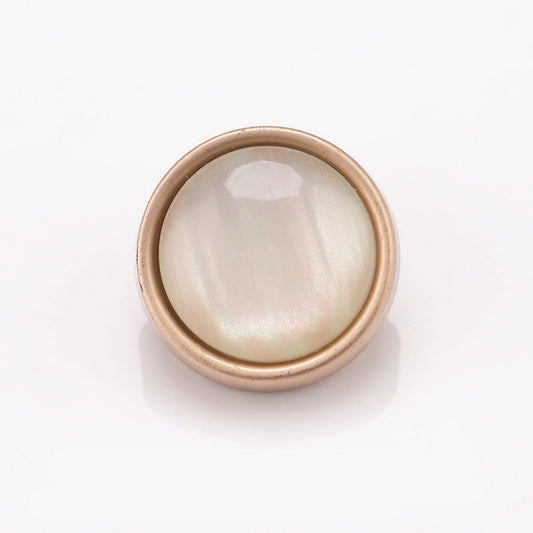 Cat-eye stone button with metal frame, matte gold rim and pearly white center
