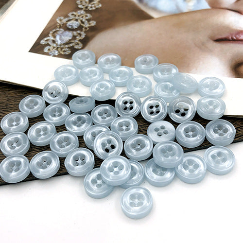 10mm pale light-blue round buttons with four holes, translucent-looking buttons visible