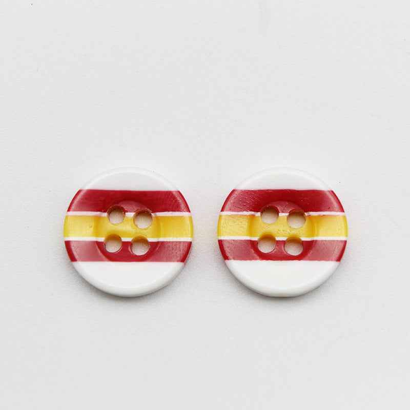 Two round resin buttons with 4 holes, candy stripes: red and yellow on white