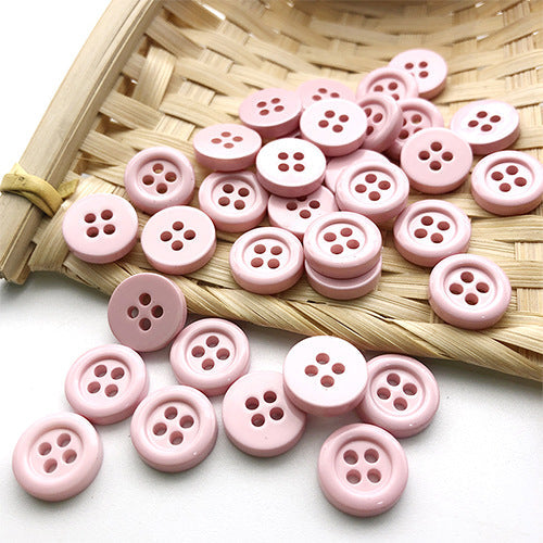 11.5mm round four-hole buttons in pink shades, mixed light and darker tones.