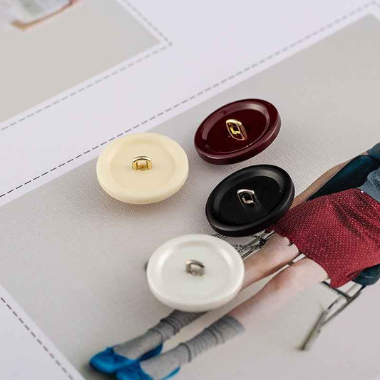 Round resin buttons with metal shank: wine, pearl white, matte black on fabric