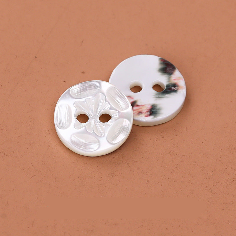 Pair of 11.5mm 2-hole troca shell buttons: white floral and mottled natural