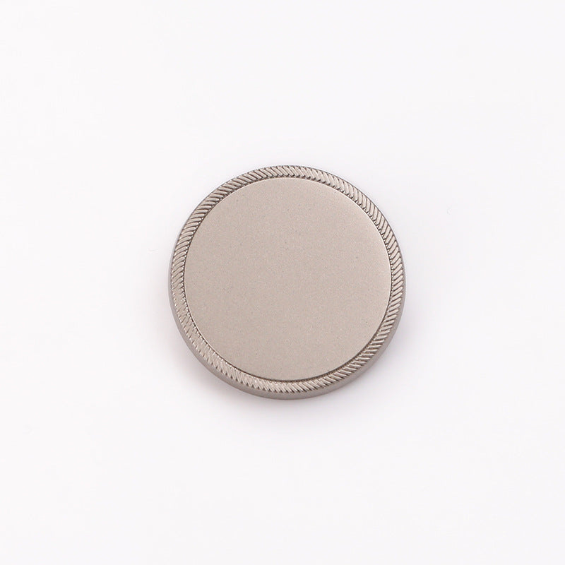 Round flat metal shank button, sand nickel, serrated rim, front view