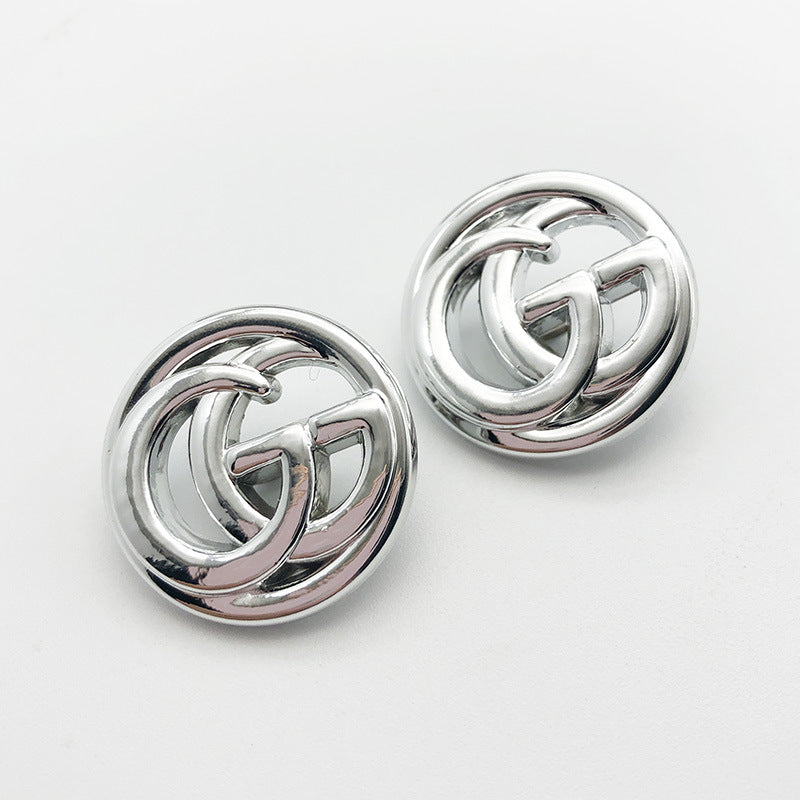 Silver double G shank plastic buttons, close-up of front and central shank
