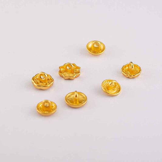 Gold-tone shirt buttons with domed faces and central hole, assorted ornate motifs