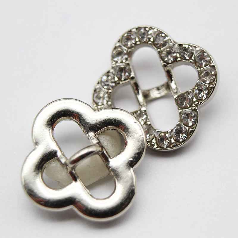 Silver-tone four-leaf clover rhinestone shank button with round crystal border
