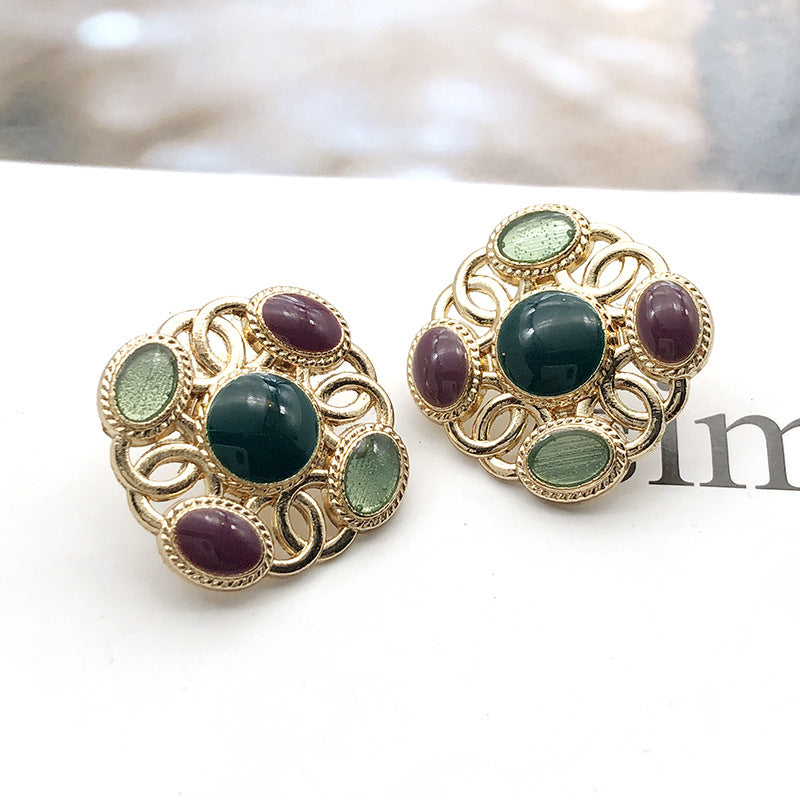 Square metal shank pearl buttons with dark green center, teal edge pearls, purple accents