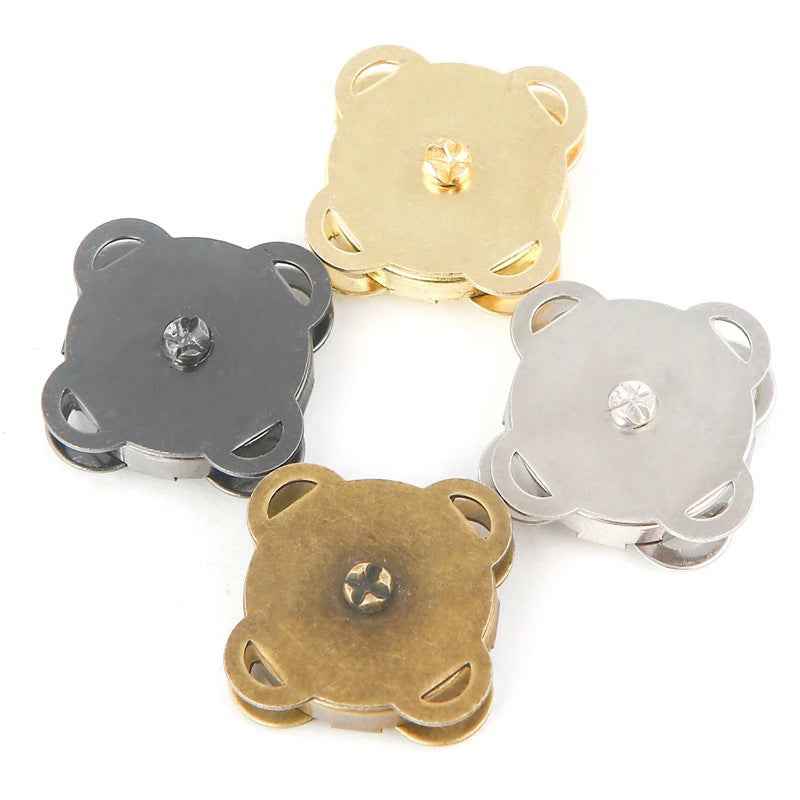 Flower-shaped metal magnetic snap buttons in gold, silver, and dark tones