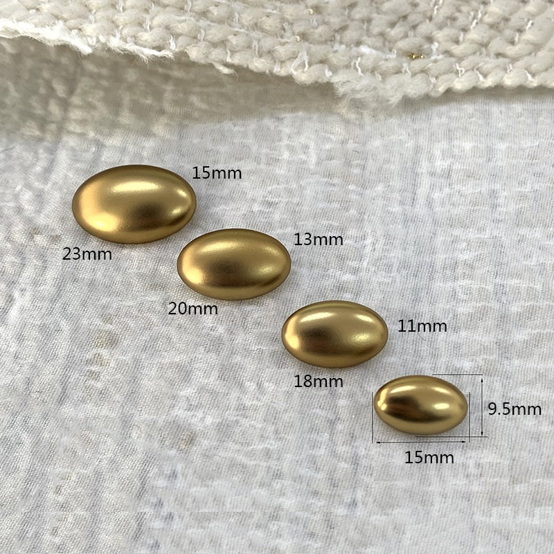Oval gold alloy shank buttons with size labels: 23mm, 20mm, 18mm, 15mm, 13mm, 11mm