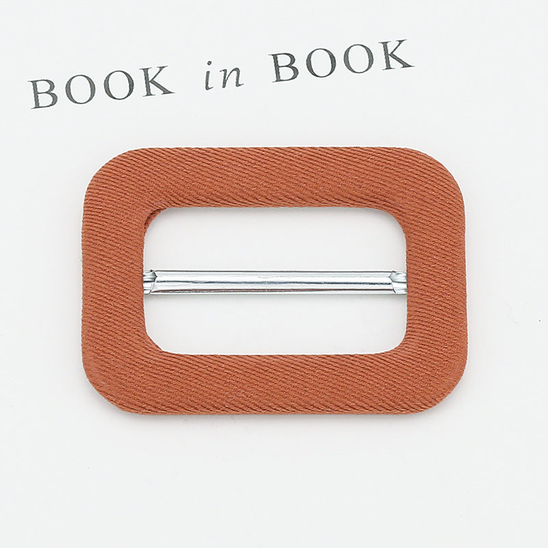 Fabric-covered metal D-ring buckle, rust orange with chrome adjustment bar